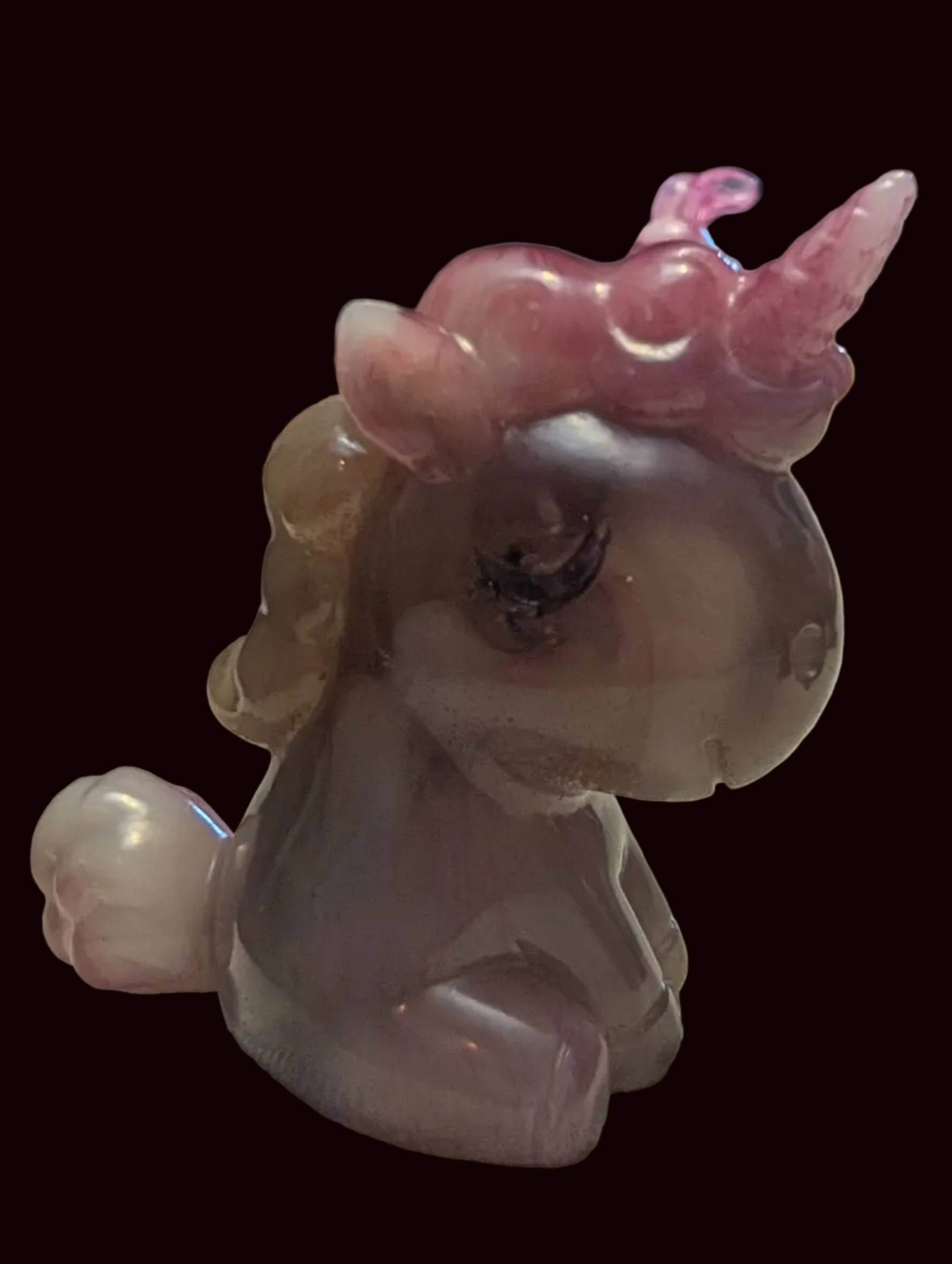 A translucent pink and mauve unicorn