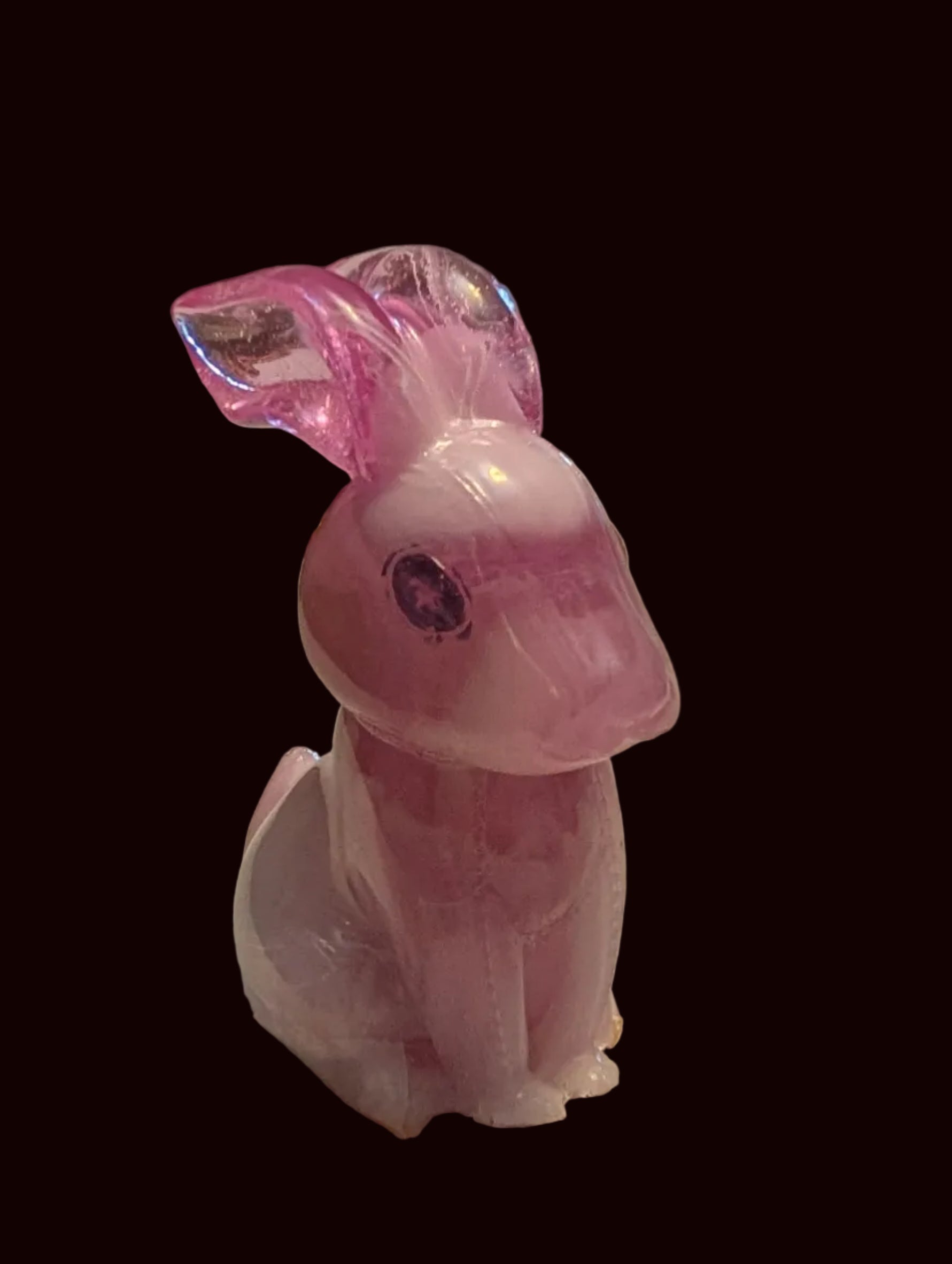 A small pink translucent rabbit figurine
